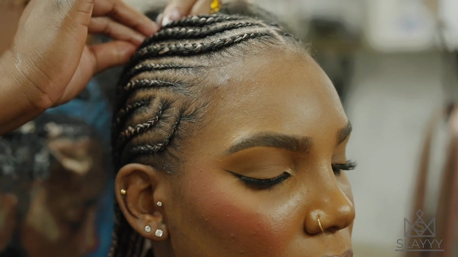 Close-up of cornrows at the hairline as SLAYYY braids are installed