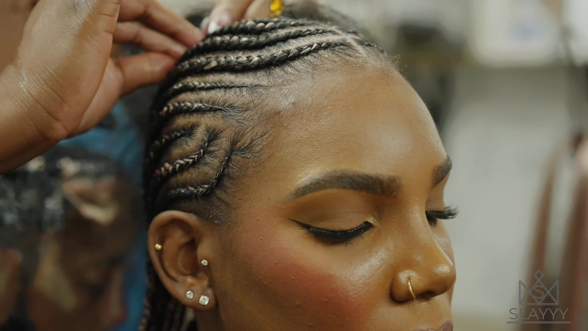 Close-up of cornrows at the hairline as SLAYYY braids are installed